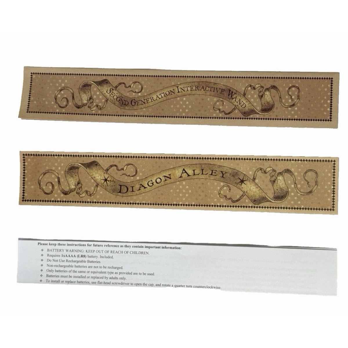 Two folded gold-toned spell-map panels and a white printed information strip displayed on a light background.