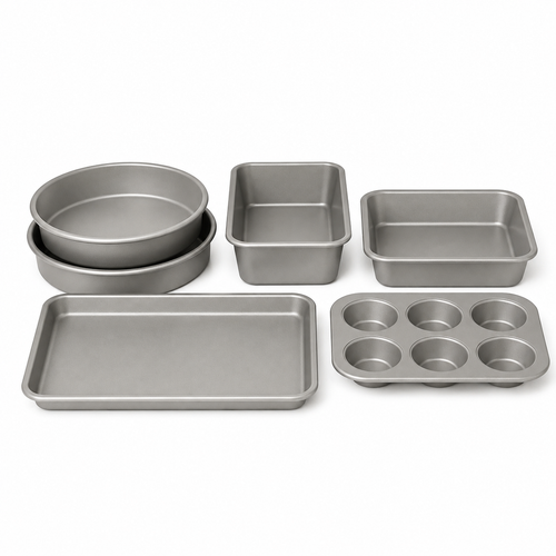 Six-piece bakeware set with two round pans, loaf pan, square pan, baking sheet and six-cup muffin pan on white.