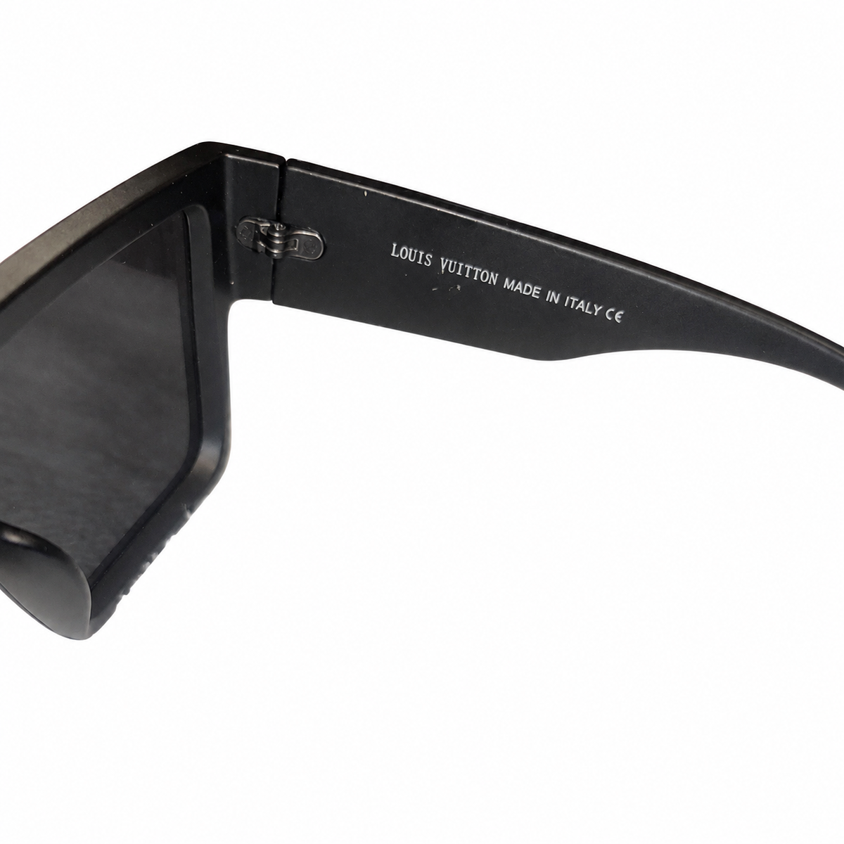 Louis Vuitton Waimea sunglasses, interior Louis Vuitton Made in Italy marking and metal hinge detail on white.